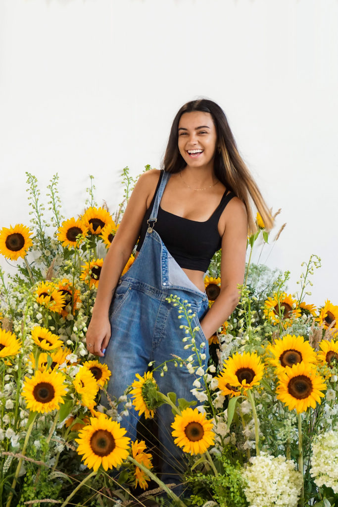 Girl standing in a large group of sunflowers